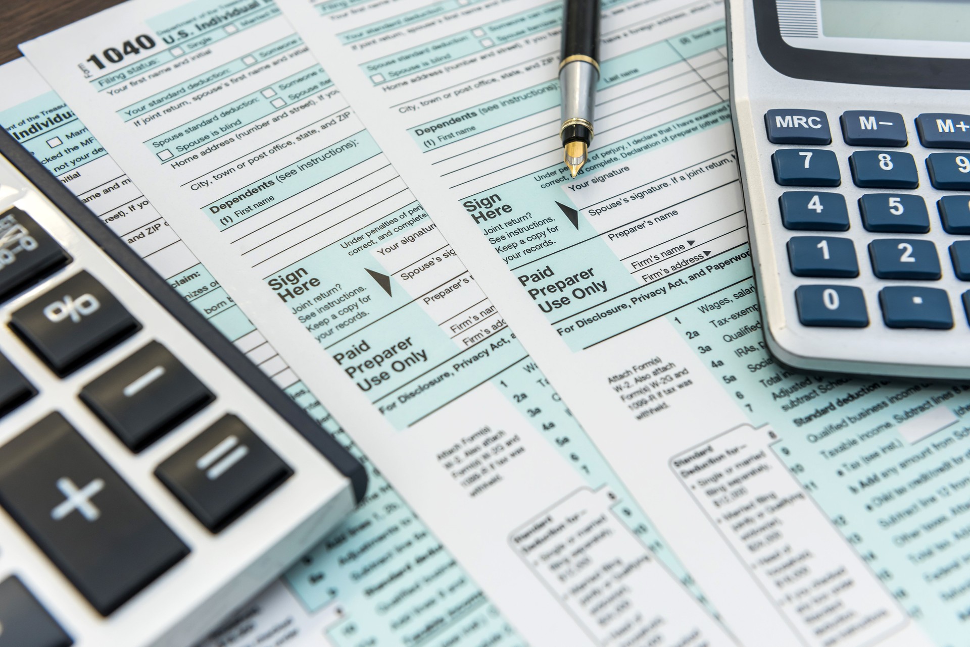 Tax Forms with Calculator and Pen. Financial accounting